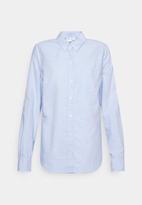 Chemise bleu clair à manches longues avec col à boutons et poche poitrine, présentée à plat sur un fond blanc.