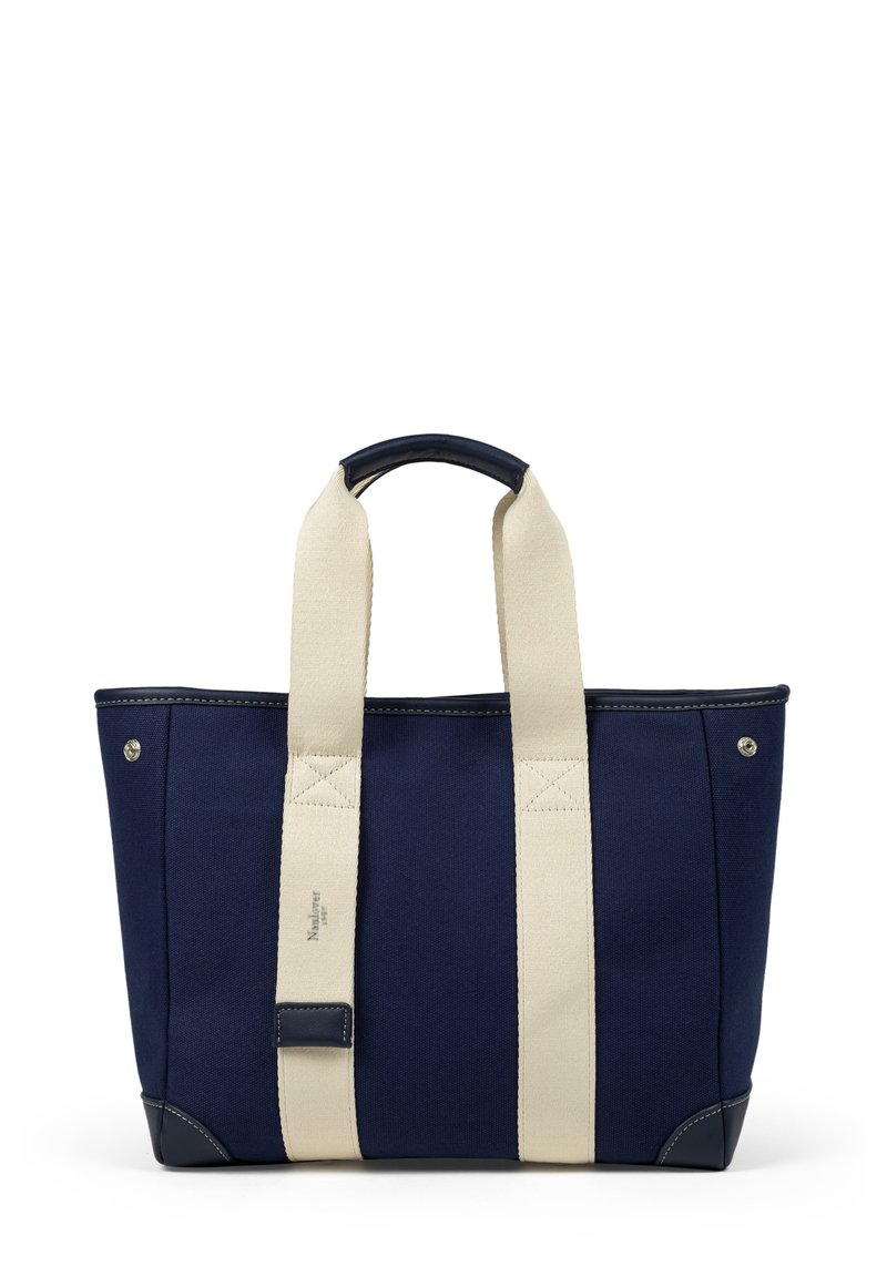 Marinblå tote-väska med krämfärgade remmar, förstärkt sömnad och en slät läderdetalj i botten, med en minimal logotypdetalj.