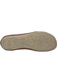Tan shoe sole with floral pattern, textured light brown rubber, and a smooth upper edge. Branding visible on the side.