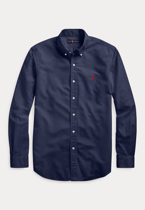 Navy blue long-sleeve button-down shirt with buttoned collar and small red embroidered logo on left chest.
