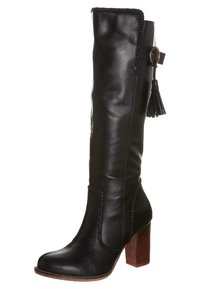 Černá kožená kotníková bota s opleteným lemem, bočními třásněmi a hnědým blokovým podpatkem. Hladká textura a kulatý tvar špičky.