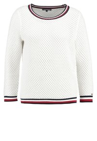 Maglione bianco lavorato a maglia con un ampio motivo a rombi, scollo rotondo accentuato da strisce rosse, blu navy e bianche all'orlo e ai polsini.