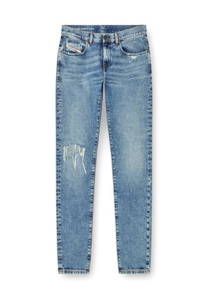 Light blue denim jeans featuring a distressed design with a large tear on the left leg, five pockets, and a straight leg cut.