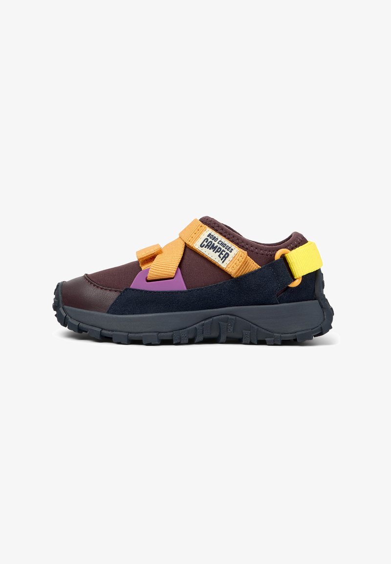 Multicolor sports shoe with dark brown upper, black sole, yellow and orange straps, purple accent, and "Bob Choses Camper" label on strap.