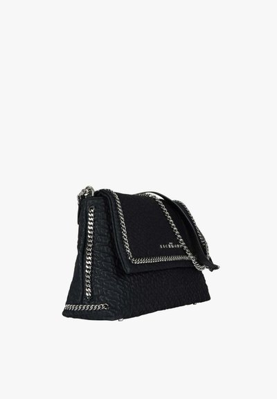 Borsa nera texturizzata con rifinitura in catena d'argento, chiusura a patta e tracolla, esposta su sfondo bianco.