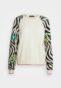 Pull en tricot avec un corps crème, des manches rayées zébrées noir et blanc ornées de motifs floraux rouges, bleus et verts ; poignets et ourlet côtelés.