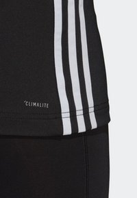 Black athletic tank top featuring white stripes, a smooth texture, and a Climalite logo near the hem.