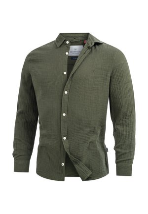 Olivenfarget knapp-up skjorte med en teksturert, quiltet stoff. Har krage, lange ermer, og hvite knapper, med et brodert logo.