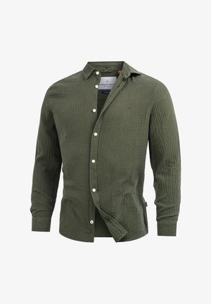 Olivenfarget knapp-up skjorte med en teksturert, quiltet stoff. Har krage, lange ermer, og hvite knapper, med et brodert logo.