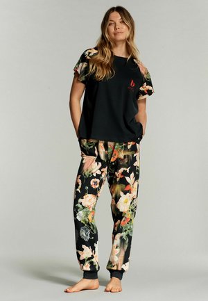 Floral pajama set featuring a black top with short sleeves and a floral pattern on sleeves, paired with matching colorful pants with elastic cuffs.