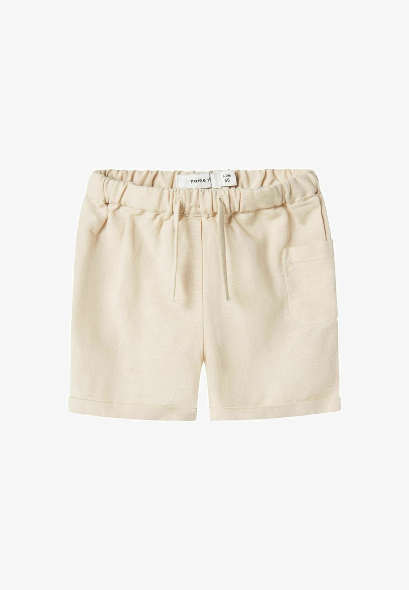 Beige shorts with an elastic waistband, drawstring detail, rolled cuffs, and a side pocket. Made from soft, lightweight fabric.