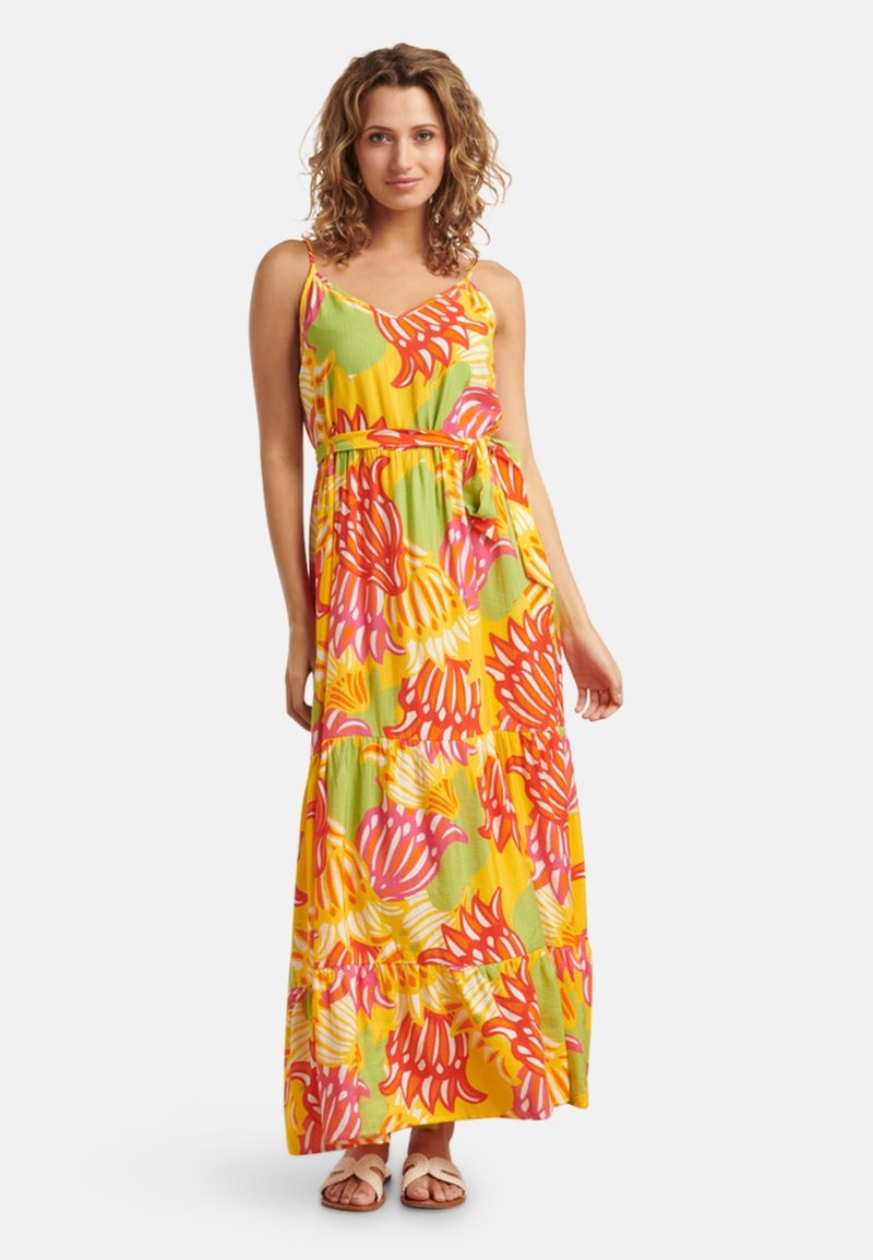 Maxi-jurk met een groen, geel en roze bloemenpatroon. Spaghettibandjes, pasvorm met een strik in de taille en een gelaagde volants onderkant. Katoenen stof.