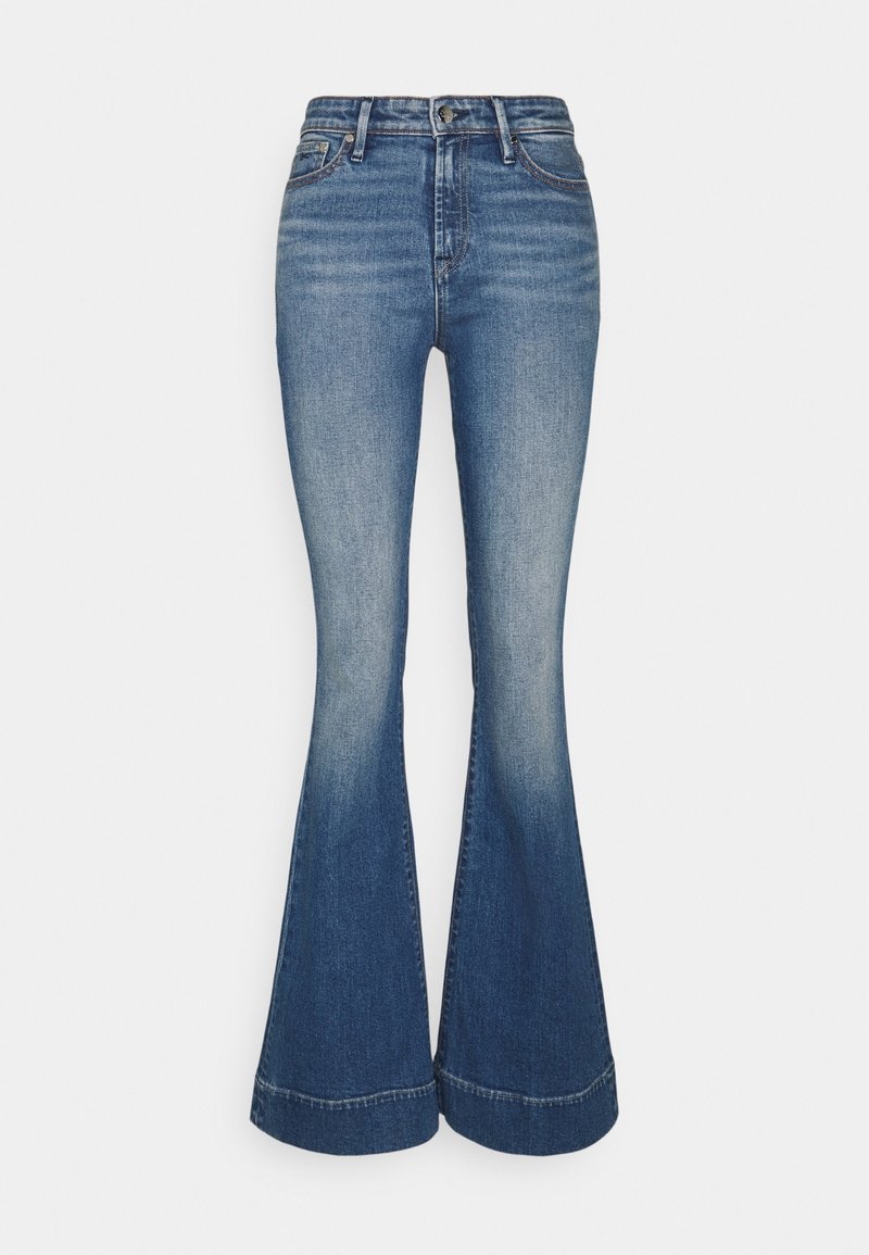 Uppfällda jeans i medelblå tvätt, med hög midja och vida ben. Slät yta med en subtil blekning och sömdetaljer vid fållen.