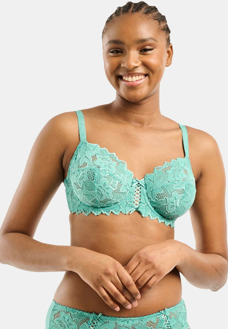 Reggiseno in pizzo teal con motivo floreale, bordi scallop e chiusura anteriore con dettagli incrociati. Spalline regolabili per una vestibilità ottimale.