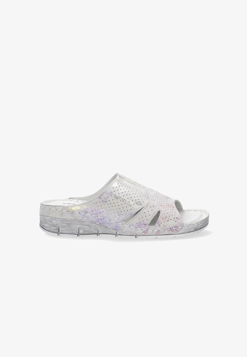 Gennemsigtig slide sandal lavet af et gennemskinneligt hvidt materiale med farverige prikker, åben tå design og tekstureret ydersål med riller.