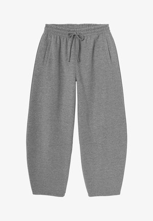 Pantalons de survêtement gris, surdimensionnés, avec une taille élastique et un cordon de serrage, dotés de poches latérales et d'un tissu doux et texturé.