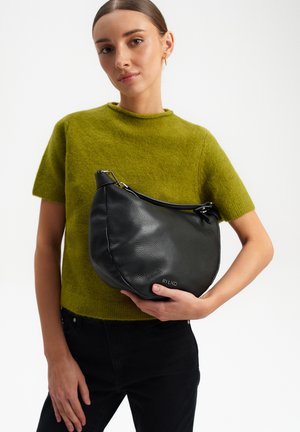 Black leather hobo bag with textured surface and silver hardware. Features a curved shape and zip closure. Logo embossed on the side.