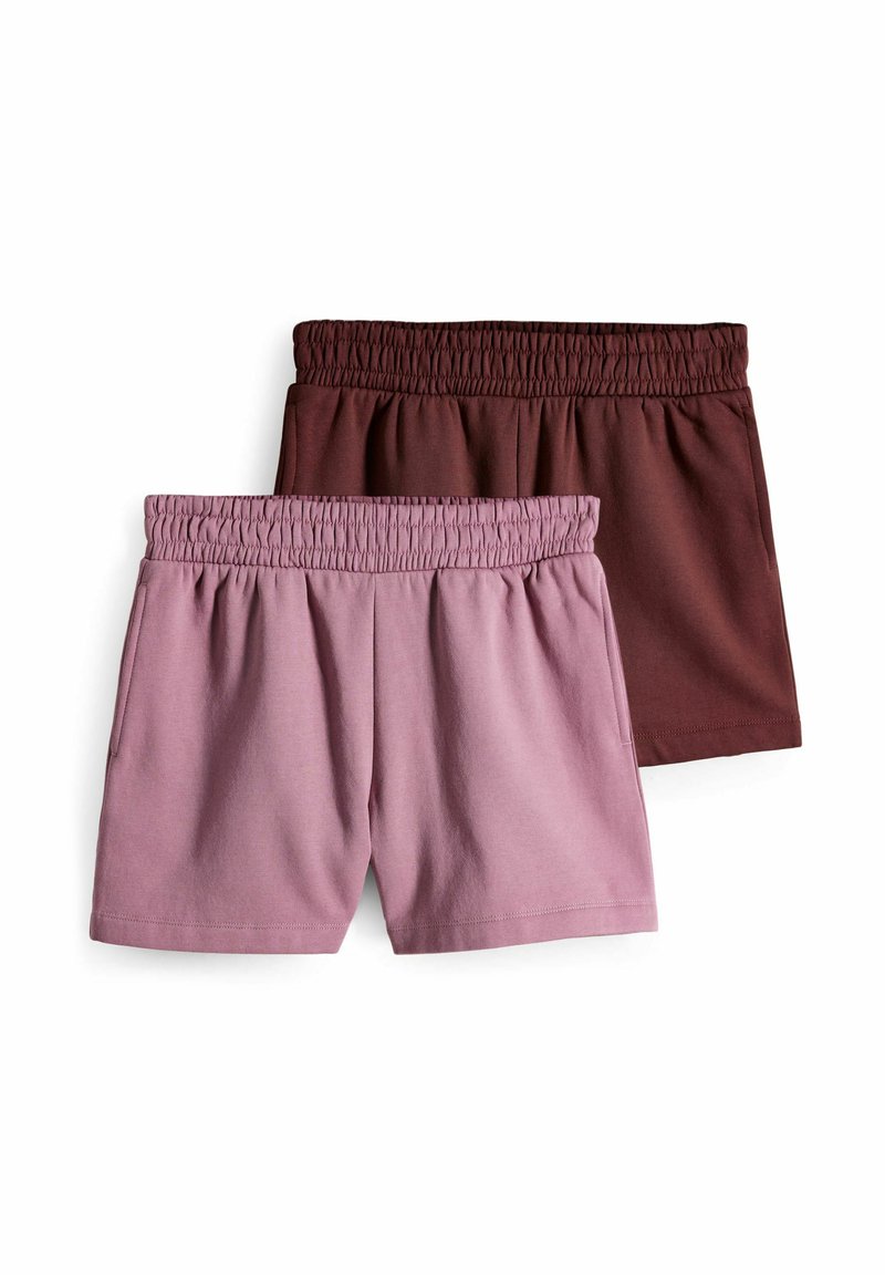 Två par shorts med elastiska midjeband, ett i mjuk rosa och det andra i djup brunt, tillverkade av lätt bomullstyg.