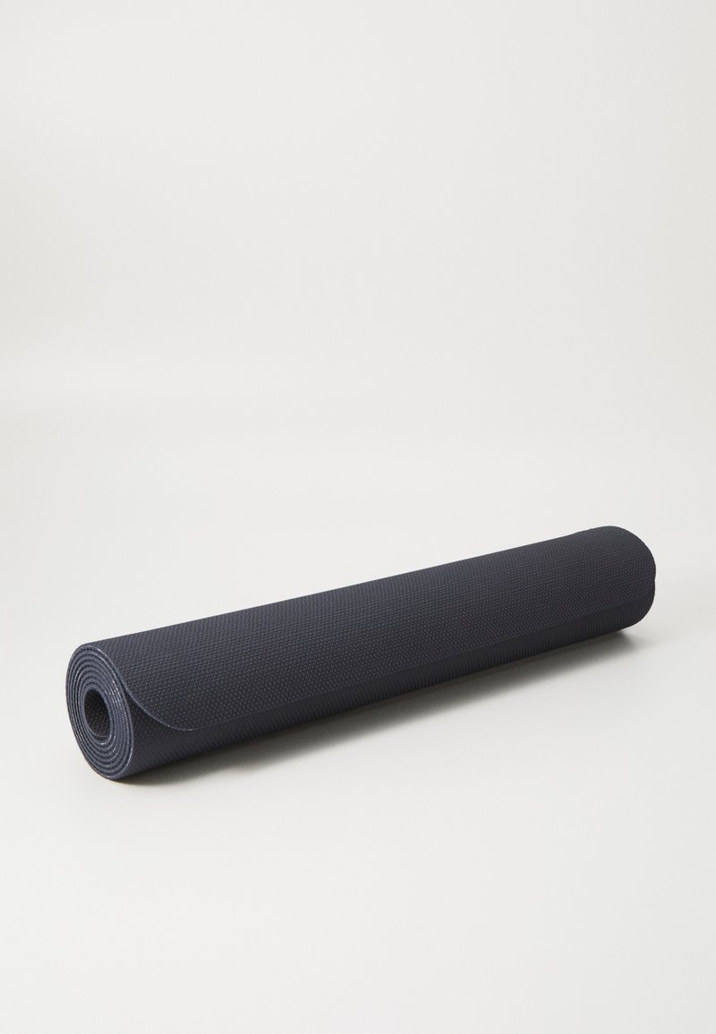 Dark blue yoga mat with a textured surface, cylindrical shape, and rolled edges. Material appears durable, suitable for exercise.