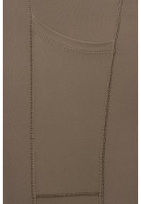 Zbliżenie brązowej tkaniny z szczegółowymi szwami tworzącymi zakrzywiony szew i pionowe linie ściegów na gładkim materiale.