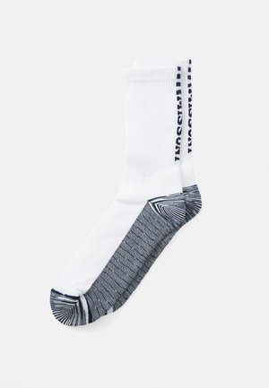 Pair of white crew socks with dark blue reinforced heel, toe, sole, and text along the cuff on a plain background.