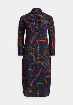 Tmavomodré šaty-košeľa s dlhými rukávmi, prednými gombíkmi, golierom s mašľou a potlačou s farebným reťazovým a lanovým vzorom v hnedých, červených a zlatých tónoch.
