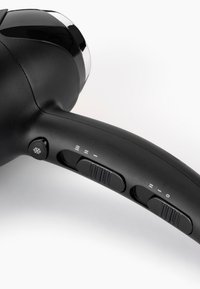 Black hair dryer handle showing cool air button and two sliding switches for heat and speed settings on a white background.