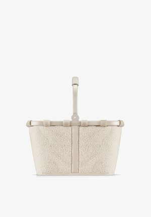 Beige woolen tote bag with a textured exterior, flat bottom, and a sleek handle. Features a simple closure and minimal hardware accents.