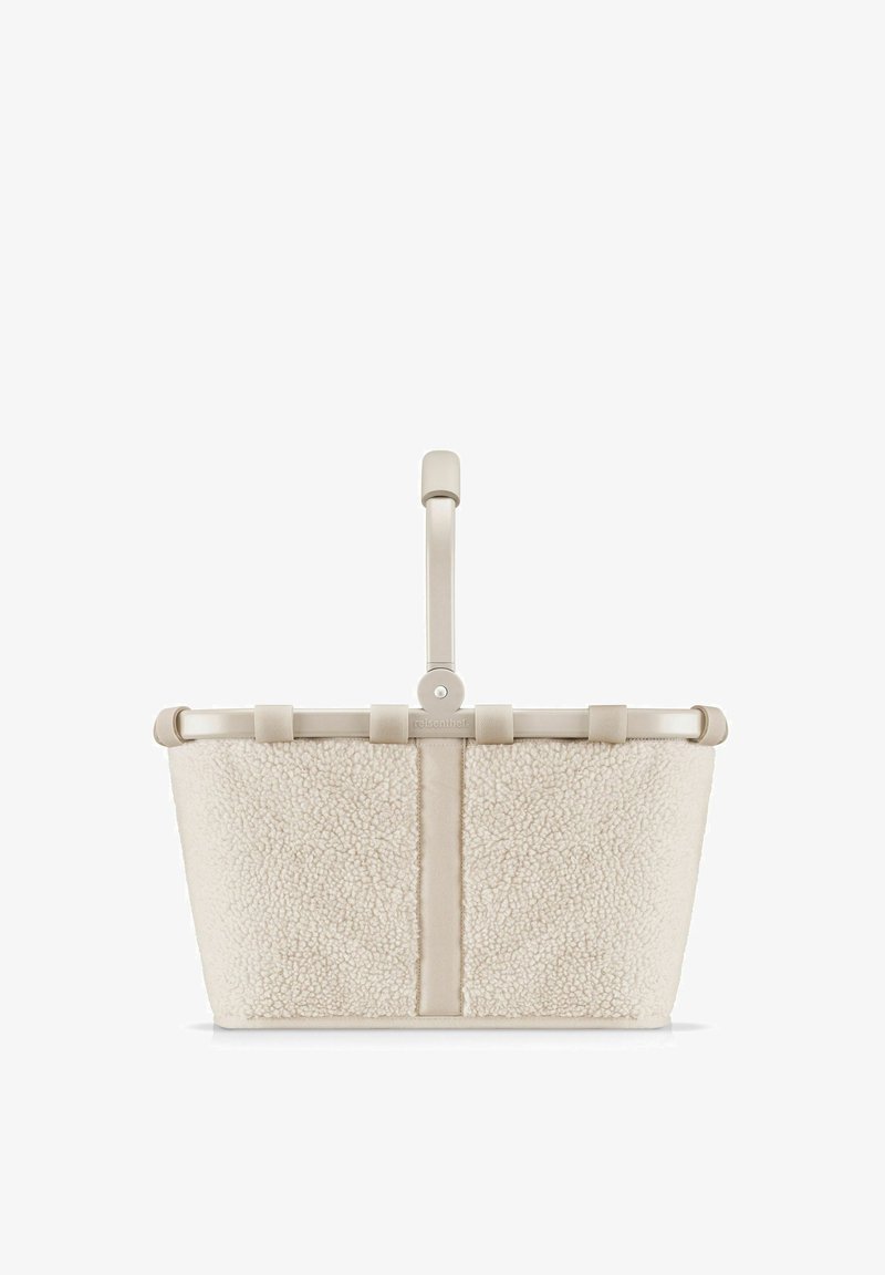 Beige wollen tote bag met een structuur buitenkant, vlakke bodem en een slanke handgreep. Voorzien van een eenvoudige sluiting en minimale hardware accenten.