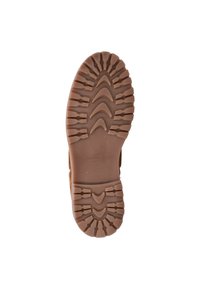 Bruine rubberen schoenzool met uitgesproken profiel met pieken en dalen voor grip, geperste merknaam en een gestructureerde afwerking.