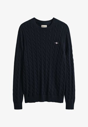 Temno modra pulover iz navijalnega bombaža z rebrastim izrezom in spodnjim robom, na prsih majhen logotip. Izdelan iz teksturiranega, mehkega materiala.