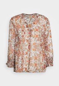 Blusa translúcida blanca con estampado floral en naranja y verde. Presenta un escote en V y mangas largas con fruncido elástico. Tela ligera.