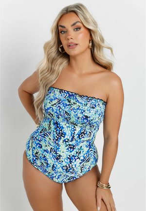 Haltersituatie, gemoffeld badpak in een blauw en groen abstract patroon. Vloeiende textuur met een aansluitende bodice en hoge beenopening.