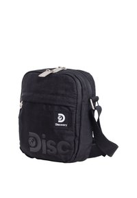 Schwarze kompakte Umhängetasche mit vorderer Reißverschlusstasche, verstellbarem Riemen und "Discovery"-Logo auf der Vorderseite.