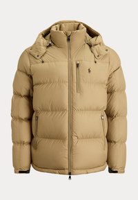 Beige padded winter jacket with a high collar, detachable hood, front zip, three zip pockets, and a small embroidered logo on the chest.