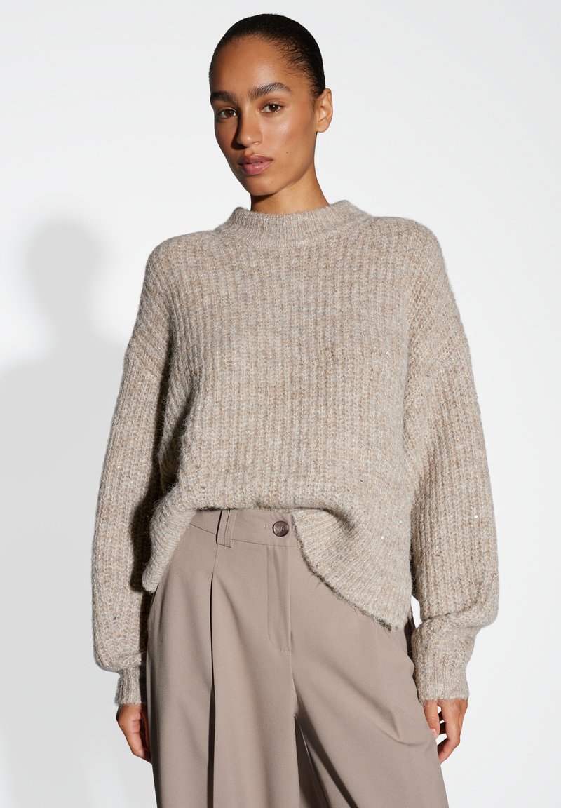 Beige ribbed knit sweater with a high neckline and drop shoulders; features a relaxed fit and subtle shine throughout the fabric.