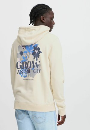 Cream-colored hooded sweatshirt featuring a floral design in blue and dark tones, with the text "GROW AS YOU GO" on the back.
