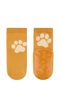 Gelbe Baumwollsocken mit einem flauschigen cremefarbenen Pfotenabdruck. Strukturierte rutschfeste Sohle mit Pfotenmustern. Glatte Oberfläche, knöchellange Ausführung.