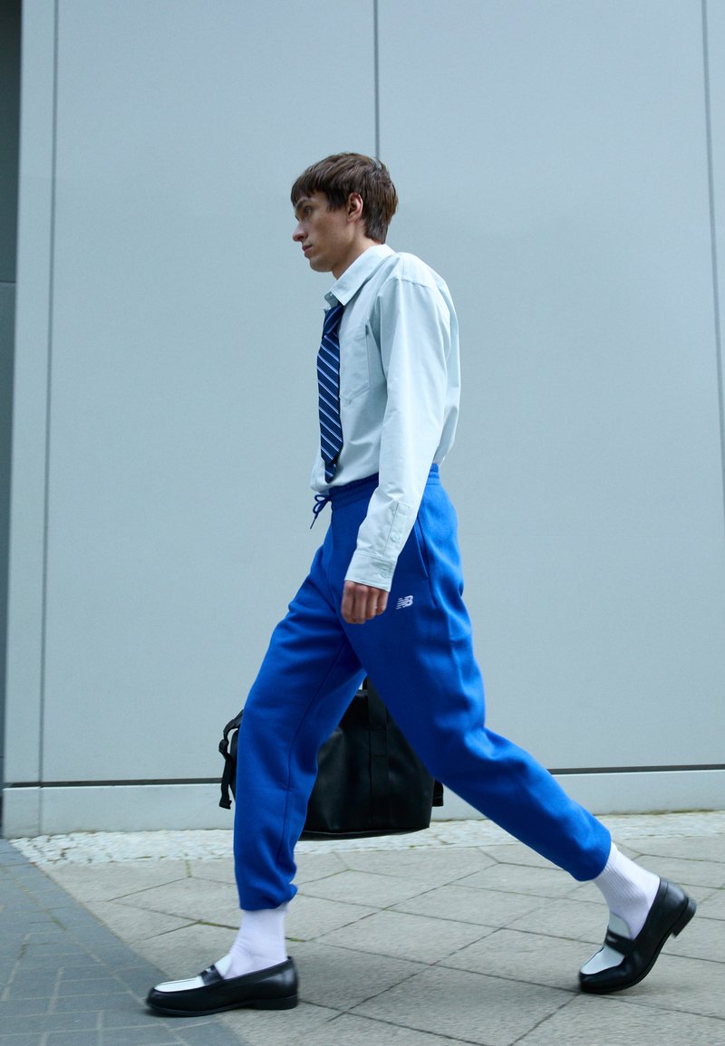 New Balance SPORT ESSENTIALS - Teplákové kalhoty - blue
