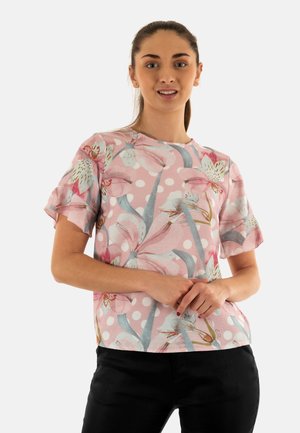 Top a maniche corte in rosa chiaro con motivo floreale e pois. Presenta un collo rotondo e un tessuto morbido con una vestibilità rilassata.