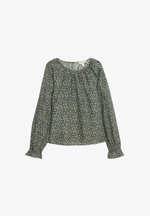 Långärmad blus i mörkgrön tyg med vitt blommönster. Har en rynkad halslinning och elastiska ärmslut för en avslappnad passform.