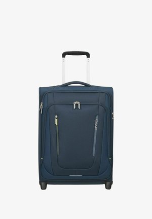 Valise souple bleu marine avec poignée télescopique, poches avant zippées, deux roues, et marque American Tourister sur fond blanc.