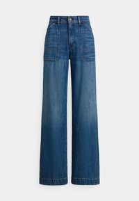 Høytlivsvidde jeans i medium blå denim. Har fremre påselommer og markante sømmer. Jevn og myk tekstur.