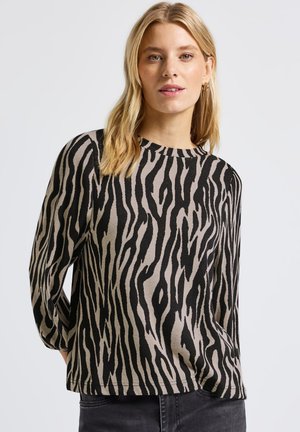 Haut à manches longues à motif zèbre beige et noir, avec un col rond et une coupe décontractée, fabriqué à partir d'un tissu doux et texturé.