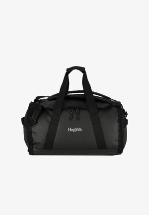 Borsa duffel nera realizzata in tessuto resistente, dotata di due manici superiori, tracolla regolabile e chiusura con zip. Logo mostrato sul lato.