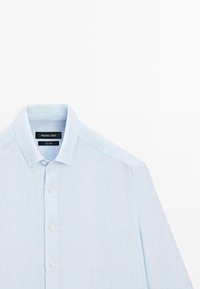 Light blue linen long-sleeve shirt with button-down collar and white buttons, labeled Massimo Dutti.