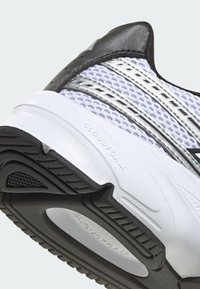 Biele športové topánky z mäkkej sieťoviny a syntetického materiálu. Čierne akcenty a strieborné pruhy. Obsahujú nápis "CLOUDFOAM" na podrážke.