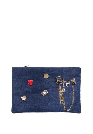 Denim pouch with a dark blue fabric, featuring gold accents, decorative charms, and enamel pins in heart and spade shapes. Zipper closure.