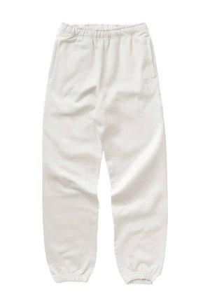 Hvide, bløde joggers lavet af stof med elastisk linning, elastiske manchetter og sidelommer. Har diskret branding på låret.