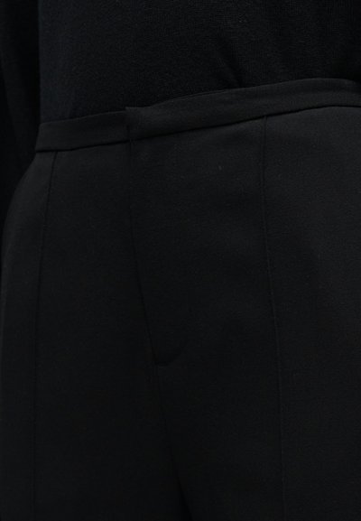 Pantalons noirs sur mesure avec une texture lisse, une coupe droite et des poches latérales discrètes, dotés d'une ceinture structurée.